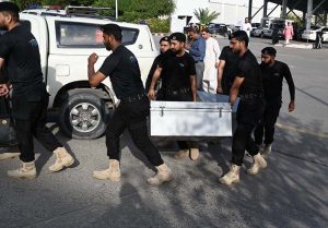 Police commandos from Pakistan’s Federal Board of Revenue (FBR) shift boxes with copies of the 2025–26 fiscal budget outside the Parliament House, before the start of the budget session