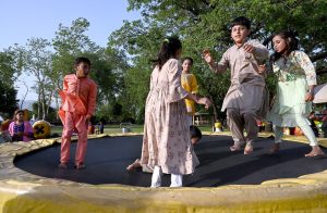 Children enjoy swing on the merry go round during their visit to Lake View Park on the second day of Eid-ul-Azha celebrations.
