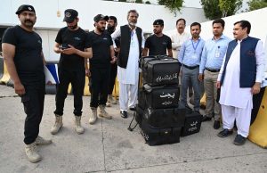 Police commandos from Pakistan’s Federal Board of Revenue (FBR) shift boxes with copies of the 2025–26 fiscal budget outside the Parliament House, before the start of the budget session