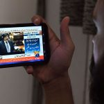 A citizen watches the live broadcast of the Sindh Budget 2025–26 on his mobile screen, presented by Sindh Chief Minister Syed Murad Ali Shah during the Sindh Assembly budget session