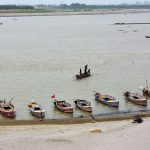 A large number of boats are moored along the banks of the Indus River in Jamshoro.