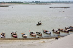 A large number of boats are moored along the banks of the Indus River in Jamshoro.