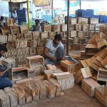 Workers busy preparing wooden crates to meet the rising demand during the peak mango season.