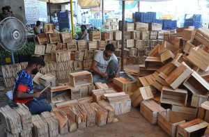 Workers busy preparing wooden crates to meet the rising demand during the peak mango season.
