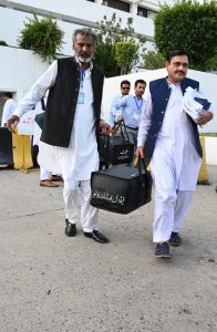 Pakistan’s Federal Board of Revenue (FBR) officials shift boxes with copies of the 2025–26 fiscal budget outside the Parliament House, before the start of the budget session