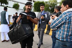 Pakistan’s Federal Board of Revenue (FBR) officials shift boxes with copies of the 2025–26 fiscal budget outside the Parliament House, before the start of the budget session