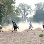 Horse riders of Omani Bike Busher Club exhibiting their skills during their visit to Tehsil Bhalwal.