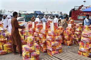 A large number of people purchasing fruits displayed by vendors at Fruit and Vegetable Market in the Federal Capital.