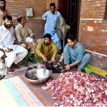 A family packing sacrificial meat for distribution on the second day of Eid ul Azha.