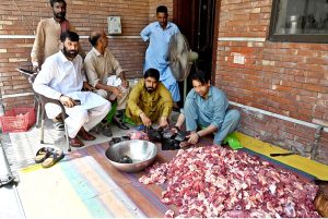 A family packing sacrificial meat for distribution on the second day of Eid ul Azha.