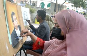 Young artists give final touches to their work during a painting and calligraphy exhibition organized by The Knowledge of Art Academy
