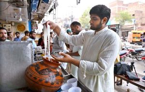 A vendor selling traditional sweet dessert falooda at his roadside stall in Muslim Bazar.