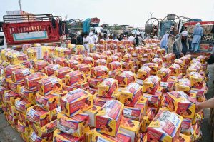 A large number of people purchasing fruits displayed by vendors at Fruit and Vegetable Market in the Federal Capital.