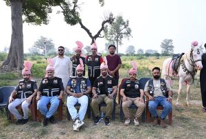Horse riders of Omani Bike Busher Club exhibiting their skills during their visit to Tehsil Bhalwal.
