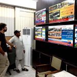 Citizens watching the 2025-26 federal budget live on television screens