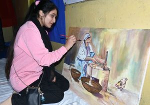 Young artists give final touches to their work during a painting and calligraphy exhibition organized by The Knowledge of Art Academy