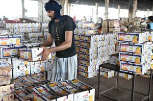 A large number of people purchasing fruits displayed by vendors at Fruit and Vegetable Market in the Federal Capital.