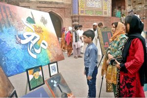 Young artists give final touches to their work during a painting and calligraphy exhibition organized by The Knowledge of Art Academy