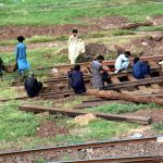 Railway workers are repairing a railway track near Lahore Railway Station.