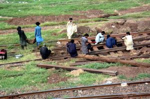 Railway workers are repairing a railway track near Lahore Railway Station.