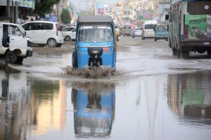 Vehicles wade through rainwater accumulated on Qayyumabad Road after heavy rainfall in Provincial Capital.