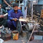 Blacksmith busy sharpen the knife to be used for slaughtering sacrificial animals during Eidul Azha