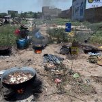 Gypsy person boiling meat after collecting on Eid ul Adha at Ring road