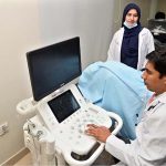 A doctor examines a patient during the trial run of the OPD at Nawaz Sharif Institute of Cardiology
