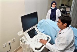 A doctor examines a patient during the trial run of the OPD at Nawaz Sharif Institute of Cardiology