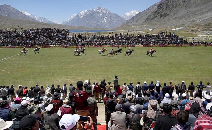 Spectators enjoy the freestyle polo match as players from Gilgit and Chitral teams compete at the world’s highest polo ground during the annual Shandur Polo Festival