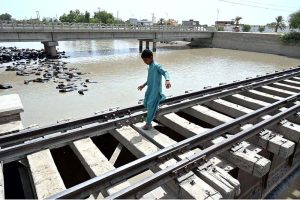 A youngster crossing the railway bridge near Nazar Muhalla