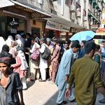 A large number of people standing in queue to purchase bus tickets at Faizabad Bus Stop to depart for their hometowns to celebrate Eidul Adha with their relatives.