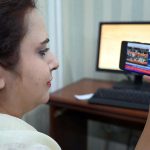 Woman watching the 2025-26 federal budget live on her Mobile screen