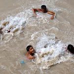 Youngsters bathing in Rice Canal to get some relief from scorching hot weather in the city