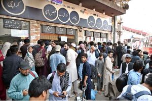 A large number of people standing in queue to purchase bus tickets at Faizabad Bus Stop to depart for their hometowns to celebrate Eidul Adha with their relatives.