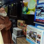 Citizens watching the 2025-26 federal budget live on television screen