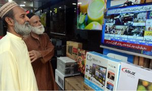 Citizens watching the 2025-26 federal budget live on television screen