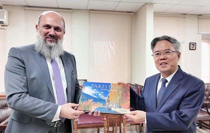 Federal Minister for Commerce Jam Kamal Khan presents the book 