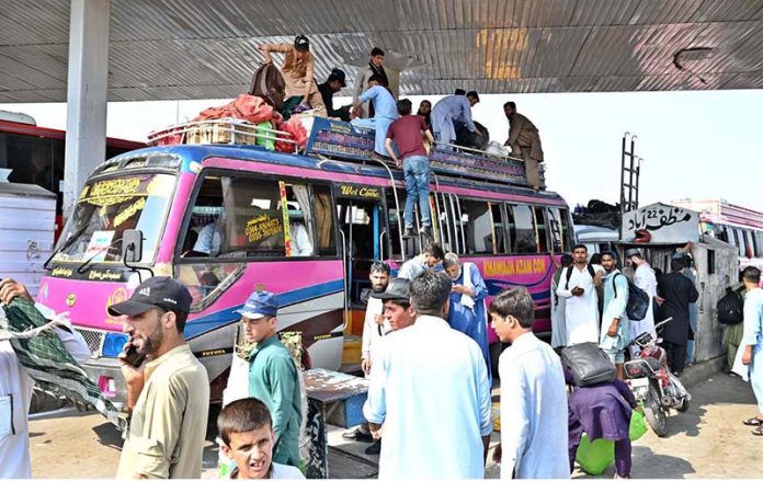 People loading their luggage on bus at Pirwadhai Bus Stop to depart for their hometowns to celebrate Eidul Adha with their relatives