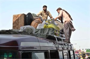 People loading their luggage on bus at Pirwadhai Bus Stop to depart for their hometowns to celebrate Eidul Adha with their relatives