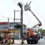 WAPDA workers remove damaged wires and install new ones during maintenance work