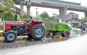 Sanitation workers wash roads as part of the ongoing Clean Punjab Campaign at Chowk Gaddafi, aiming to improve hygiene and enhance urban beautification