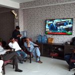 Citizens watching the 2025-26 federal budget live on television screen