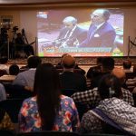 Business community watching the 2025-26 federal budget live on television screen at Chamber of Commerce