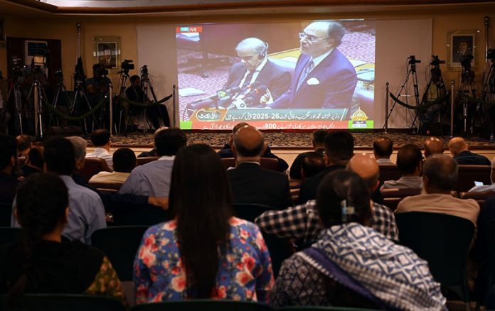 Business community watching the 2025-26 federal budget live on television screen at Chamber of Commerce