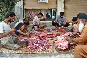 Butchers slaughtering sacrificial animal on 1st day of Eidul Azha in Provincial Capital