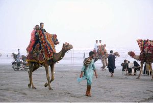 Despite the scorching heat, a family enjoys a horseback ride along the breezy coast of Seaview to enjoy a summer vacation by the sea