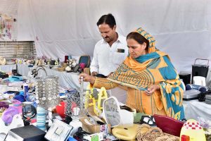 A family is selecting and purchasing household branded electronics goods from a shop