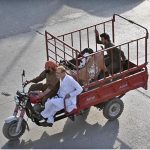 A customer transports a sacrificial animal on a delivery auto after purchase, ahead of Eid-ul-Azha, near Zia Masjid, in preparation to fulfill the holy Sunnah of Hazrat Ibrahim (AS)