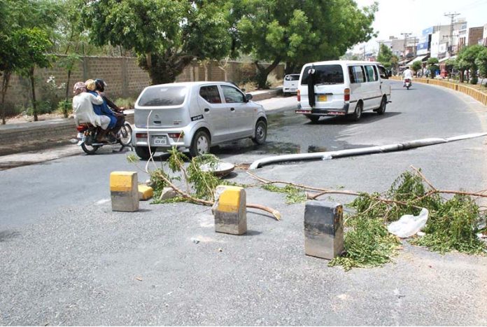 Open main hole of sewerage system on main roads of the city posing threat to passersby and routine traffic
